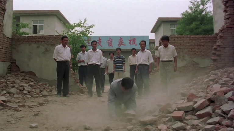 Shlnsccr2001, A Group Of Men Stands In A Dusty, Rubble-strew...