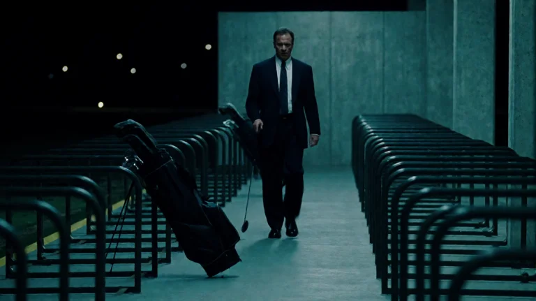 Insdr1999, A Man In A Dark Suit And Tie Walks Slowly Across...