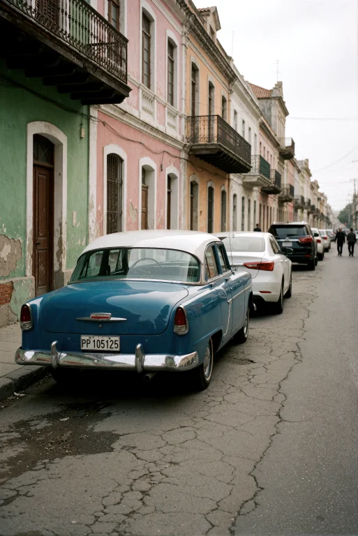 A Vintage Blue And White 1950s American Sedan Parked On The...