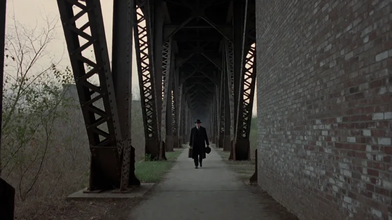 Rdtprdtn2002, A Solitary Figure In A Dark Coat And Hat Walks...