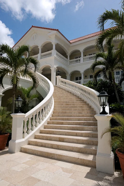 A Wide, Gently Curving Staircase Made Of Light-colored Stone...