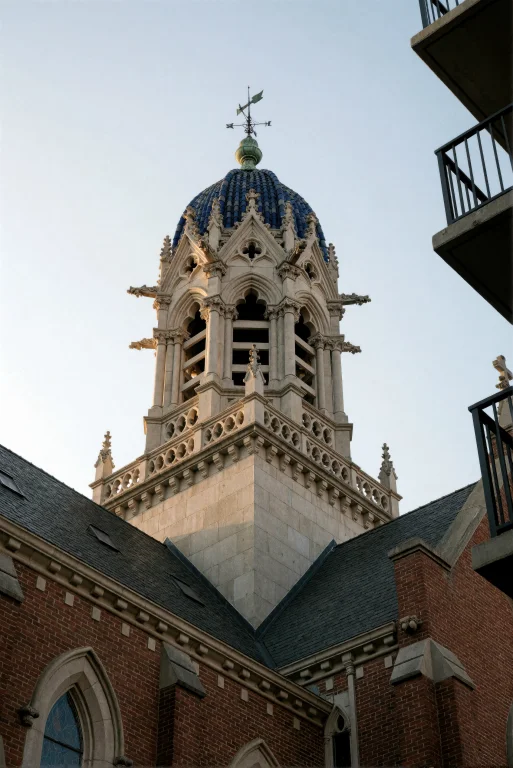 A Low-angle Shot Of A Tall, Ornate Stone Bell Tower Rising A...