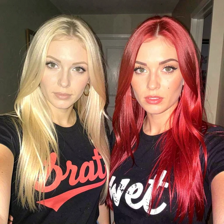 Two Hot Chicks, One Blonde And One Redhead, Stare Into The C...