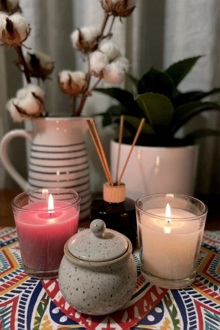A Cozy, Dimly Lit Tabletop Scene Featuring Three Lit Candles... — Stable Diffusion AI Prompt: A cozy, dimly lit tabletop scene featuring three lit candles in glass holders, o...