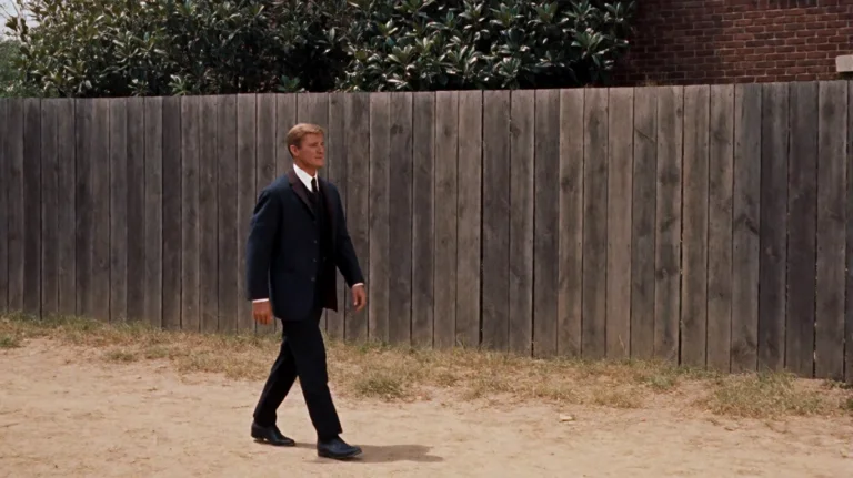 Tmmchn1960, A Man In A Dark Suit And Tie Walks From Left To...