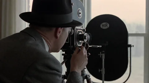 Rdtprdtn2002, A Man In A Dark Fedora And Textured Gray Suit... — Stable Diffusion AI Prompt: rdtprdtn2002, A man in a dark fedora and textured gray suit is intently operatin...