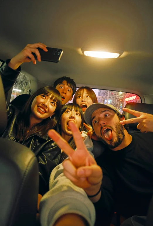 A Nighttime Selfie Taken Inside A Cramped Sedan. Five Young...