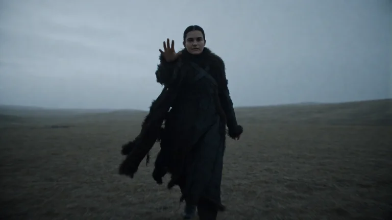 Gmthrnsssn6, A Lone Figure, Clad In Tattered, Dark Fur-lined...