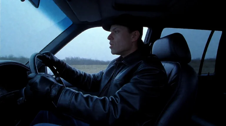 Otsght, A Person Wearing A Black Leather Jacket And A Cap Si...