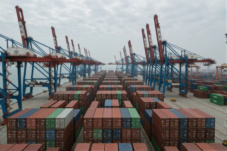 An Immense Container Port Stretches Along The Coastline, Col...