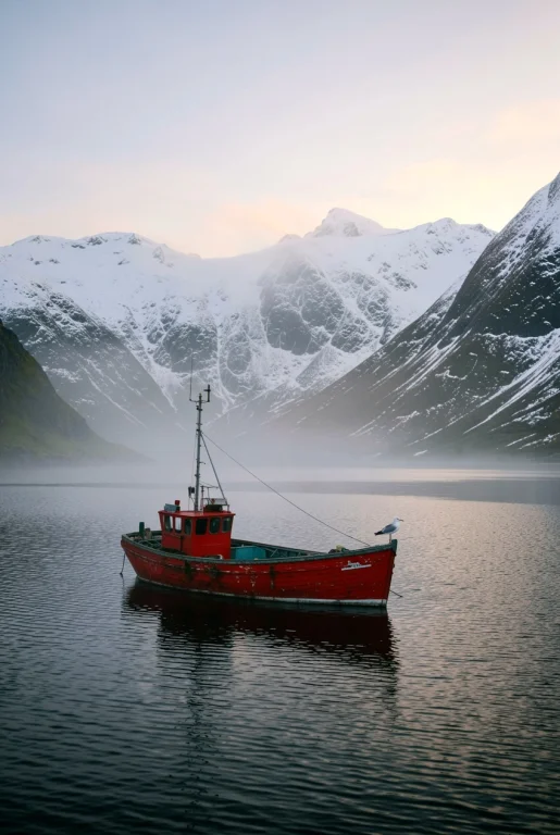 An Old Red Fishing Boat Moored In A Foggy Norwegian Fjord At...