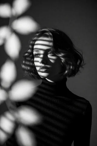 Highleveldescriptioncinematic Black-and-white Noir Portrait... — Stable Diffusion AI Prompt: {"high_level_description":"Cinematic black-and-white noir portrait of a young wo...