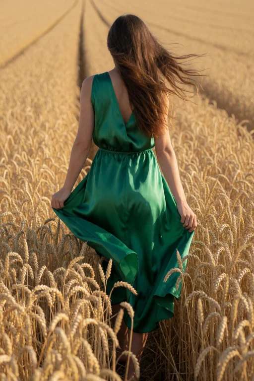 A Photograph Of A Woman In Her Twenties In A Flowing Emerald...