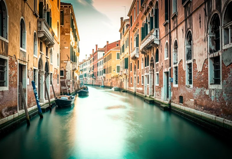 A Venetian Canal Lined With Weathered Palazzos, High Key Lig...