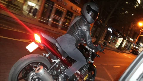 Candidsnap, A Woman In A Jet Black Full-face Helmet With A D... — Stable Diffusion AI Prompt: candid_snap, A woman in a jet black full-face helmet with a dark tinted visor ri...