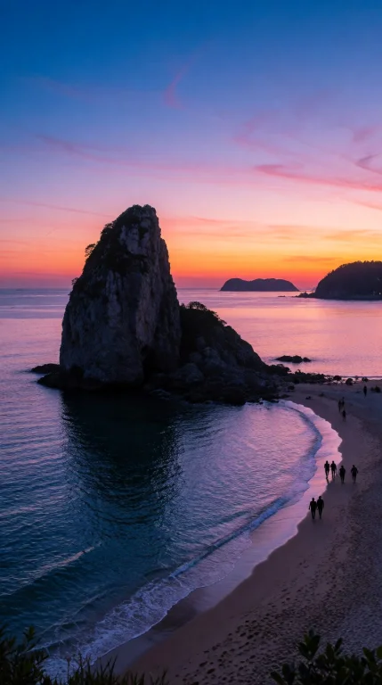 A Massive Dark Limestone Sea Stack Towers Over A Tranquil Ba...
