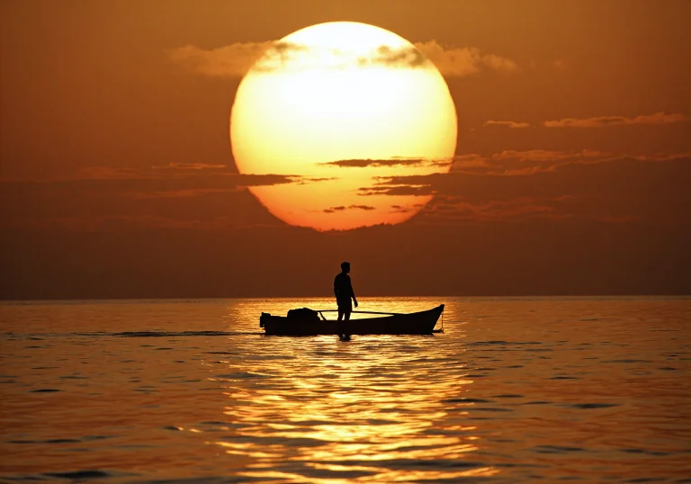 Lone Silhouetted Figure Standing In A Small Rowboat, Calm Wa...