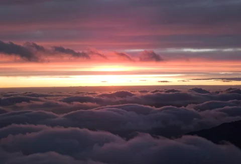 A Photograph Of A Beautiful Evening Sunset Above The Clouds — FLUX AI Prompt: a photograph of a beautiful evening sunset above the clouds