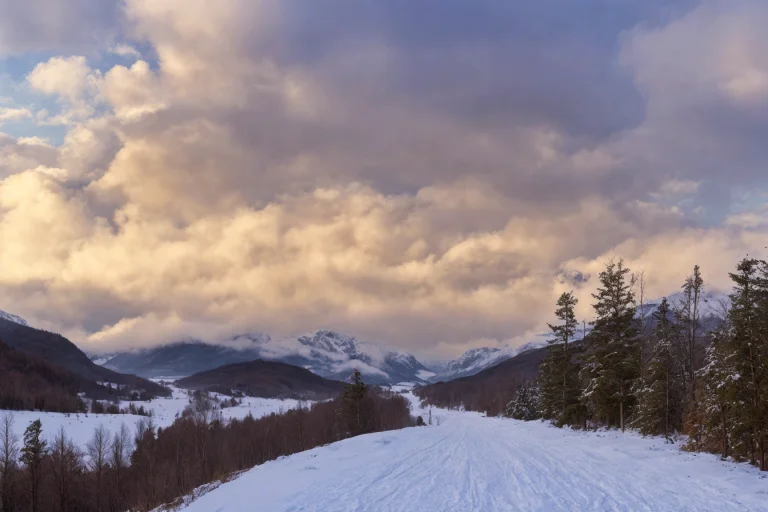 A Large Body Of Water With Snowy Mountains In The Background...