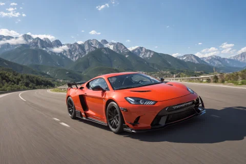 A Photo Taken Of The Front Of A Super-car Drifting On A Road... — Stable Diffusion AI Prompt: a photo taken of the front of a super-car drifting on a road near mountains at h...