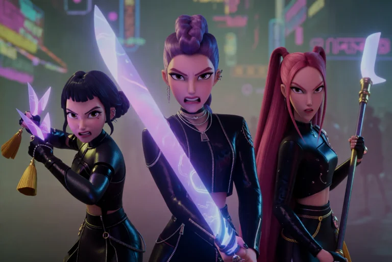 Zoey Stands On The Left With Short Dark Hair And A Black Fit...