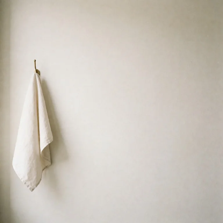 A Crisp Off-white Linen Napkin Draped Loosely Over A Single...