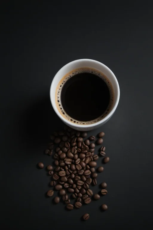A Cup Of Coffee With Coffee Beans On A Black Background,lora...