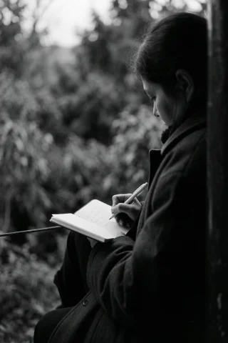 Black And White Film Photography, Person Wearing A Heavy Dar... — Stable Diffusion AI Prompt: black and white film photography, person wearing a heavy dark coat sitting outdo...