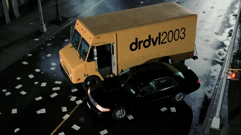 Drdvl2003, A Yellow Delivery Truck And A Black Sedan Are Loc...