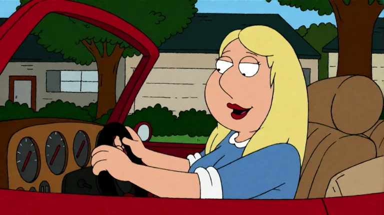 Fmlygyssn01, A Blonde Woman In A Blue Top Is Driving A Red C...