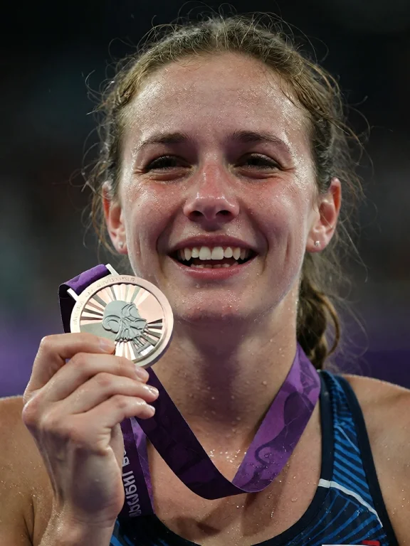 A Woman Stands Visibly Emotional, Sweat Glistening On Her Sk...