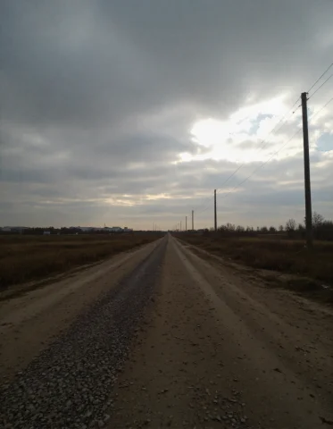 Addmicrodetails, A Long, Unpaved Dirt Road Stretches Into Th... — FLUX AI Prompt: addmicrodetails, A long, unpaved dirt road stretches into the distance under a h...