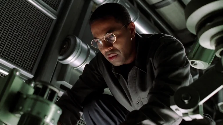 Cr2003, A Man With Round Glasses And A Dark Complexion Is Cr...