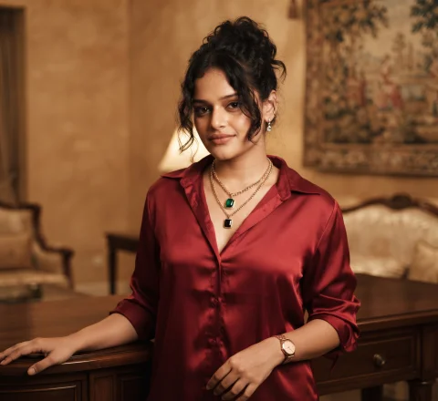 Luxury Red Satin Blouse Portrait – Cinematic Editorial AI Prompt — Nano Banana AI Prompt: A cinematic indoor portrait of a woman standing with a relaxed posture, one hand...