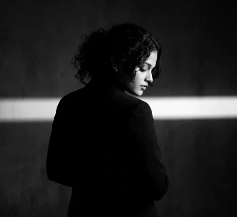 Dramatic Black and White Silhouette Portrait – Cinematic High-Contrast Fashion Editorial AI Prompt — Nano Banana AI Prompt: A dramatic black and white studio portrait. The subject stands with their back t...