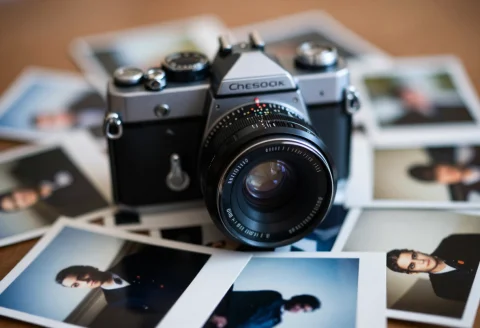 An Old Camera Surrounded By Loose Photographs, Extreme Close... — Stable Diffusion AI Prompt: an old camera surrounded by loose photographs, extreme close-up, dreamy atmosphe...