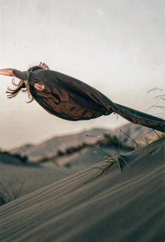 A Flowing Cape Lifted On A Windy Dune, Documentary Photograp... — Stable Diffusion AI Prompt: a flowing cape lifted on a windy dune, documentary photography, telephoto compre...