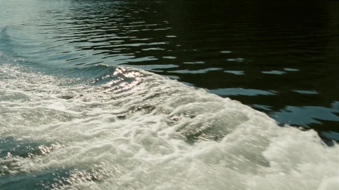 Intwld2007, A Dynamic Wake Of Foamy White Water Churns Acros... — Stable Diffusion AI Prompt: intwld2007, A dynamic wake of foamy white water churns across the foreground, tr...