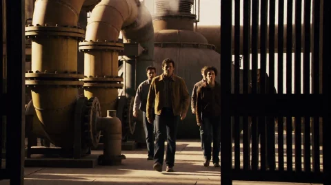 Nxt2007, A Man In A Tan Jacket Walks Forward Through A Dimly... — Stable Diffusion AI Prompt: nxt2007, A man in a tan jacket walks forward through a dimly lit industrial faci...