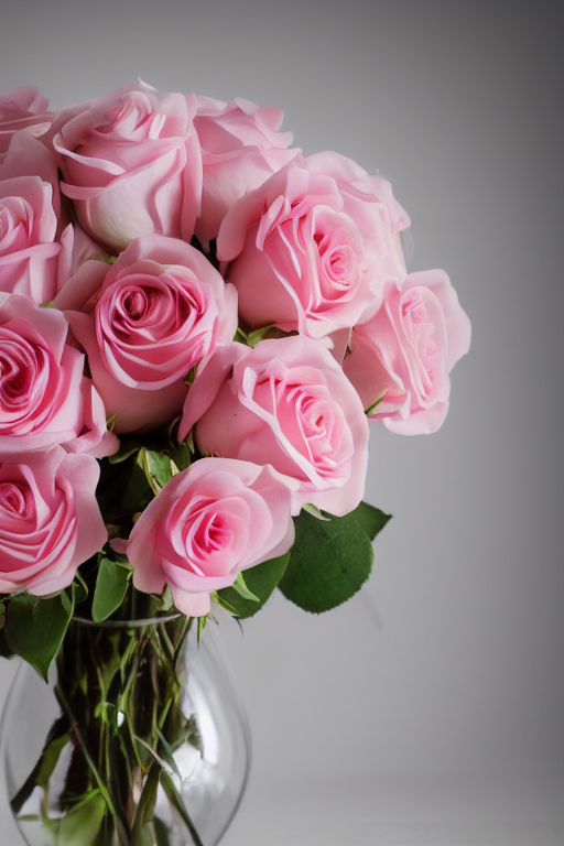 A Glass Vase Of Beautiful Pink Roses, Tied With Chiffon Bow,...